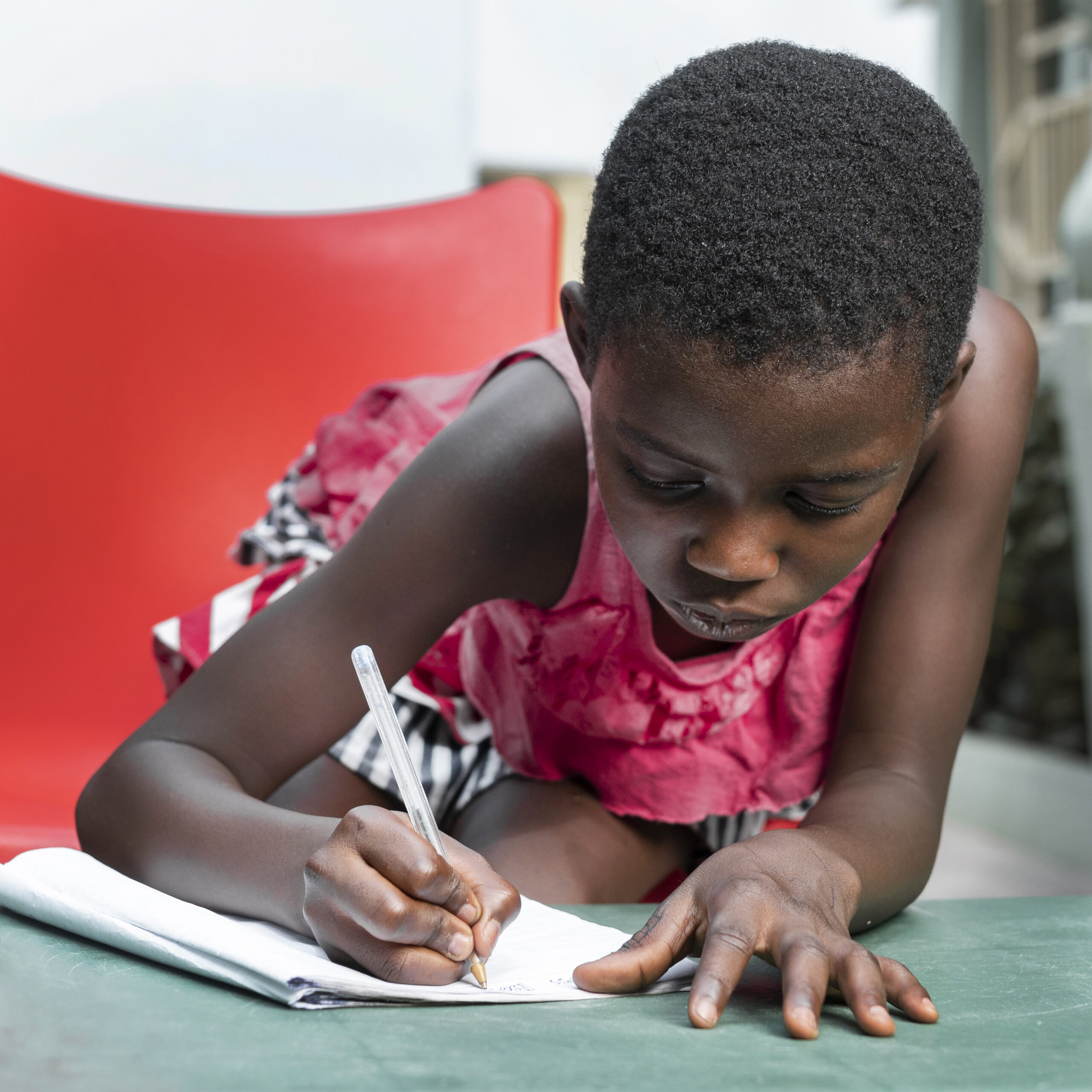 medium-shot-girl-writing-notebook