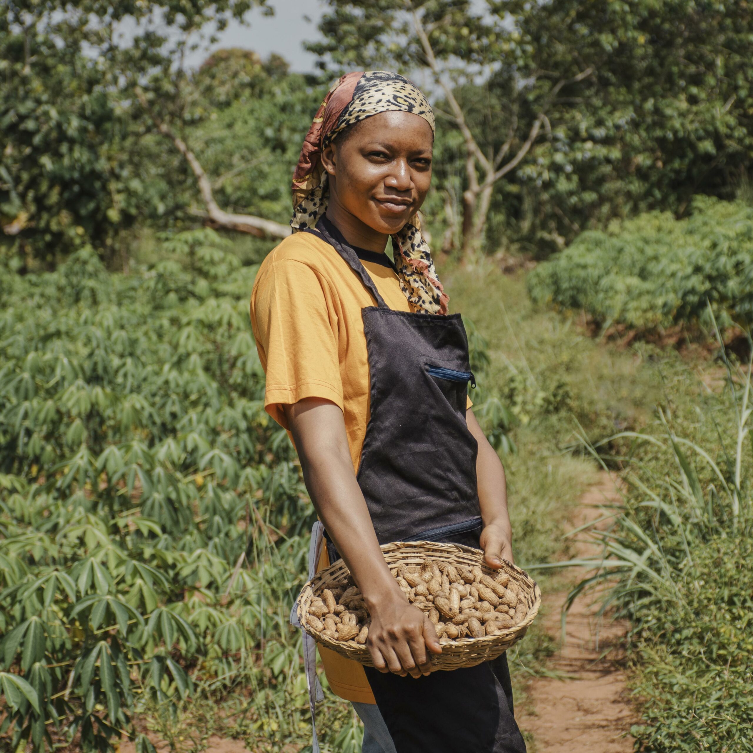 African woman with basket in forest